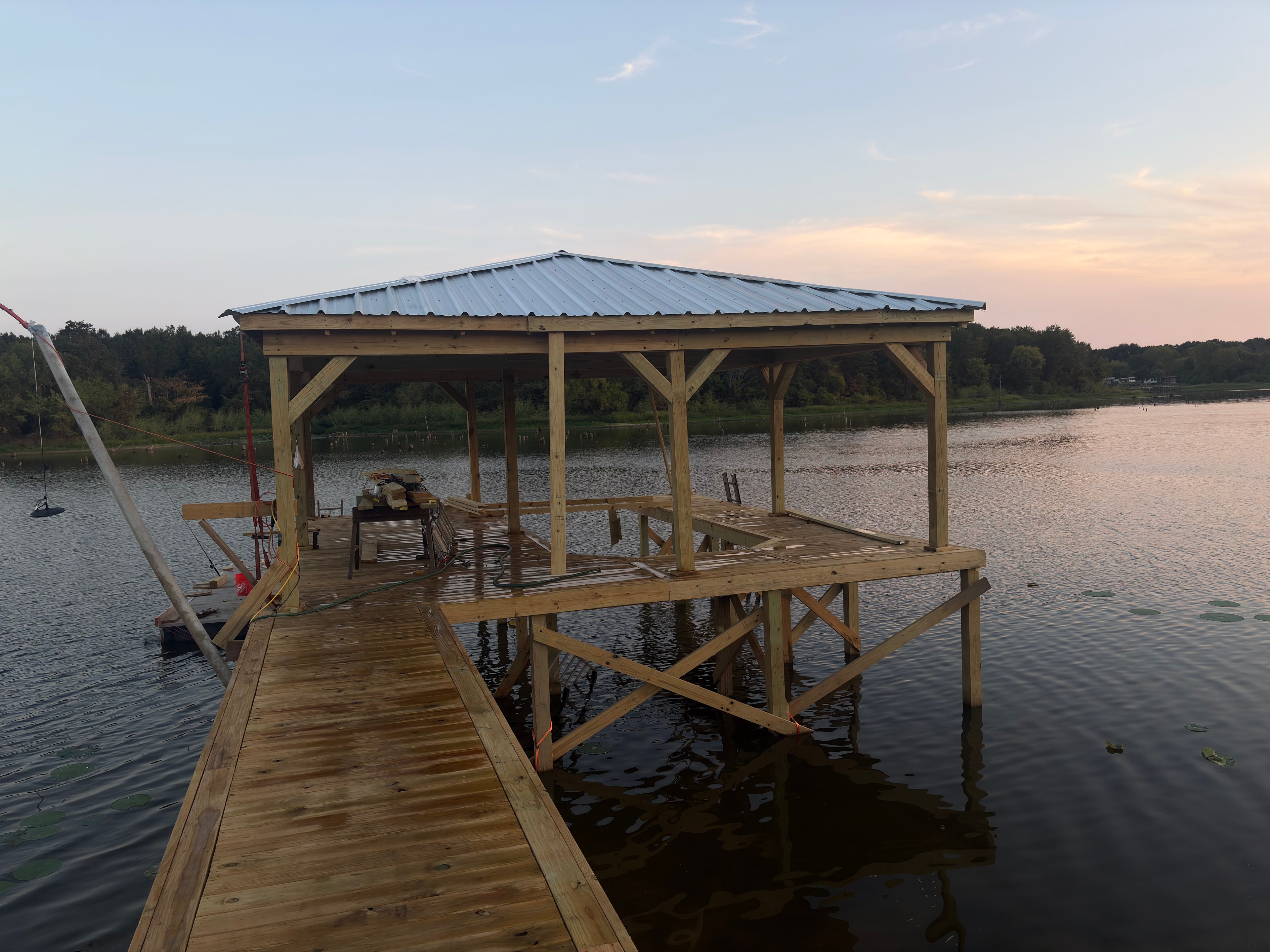 Custom covered boat dock and boathouse construction on East Texas lake by TW Construction